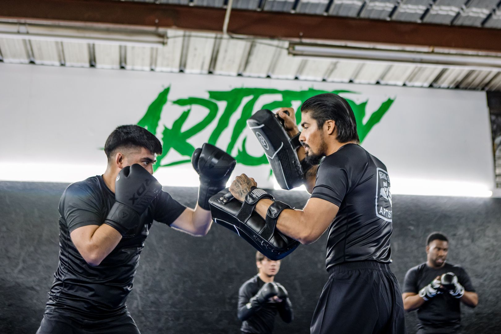 Adults drilling Brazilian Jiu Jitsu at Artistry BJJ in Houston, TX, building resilience.
