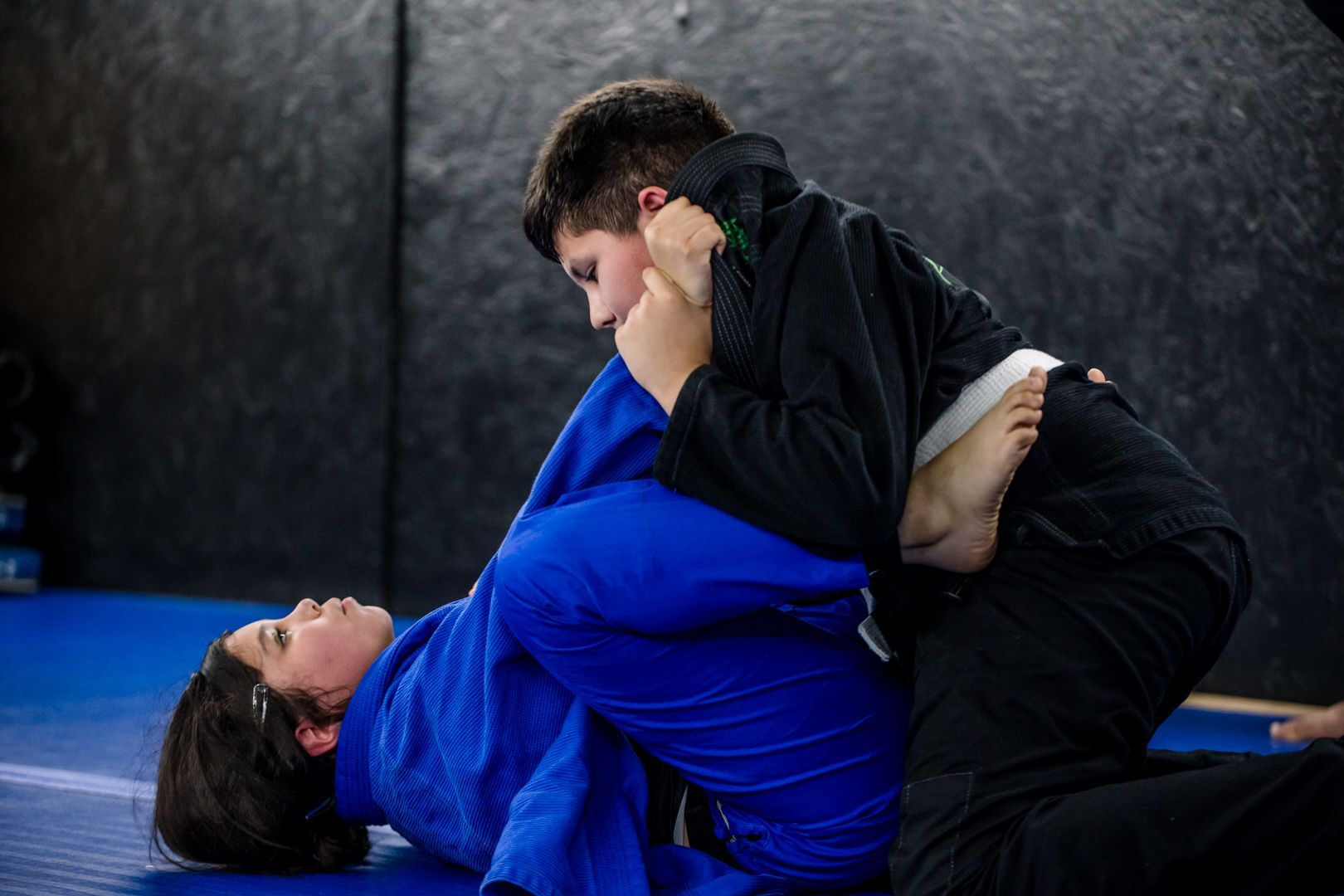 Kids training Youth Brazilian Jiu Jitsu at Artistry BJJ in Houston, Texas, building confidence.