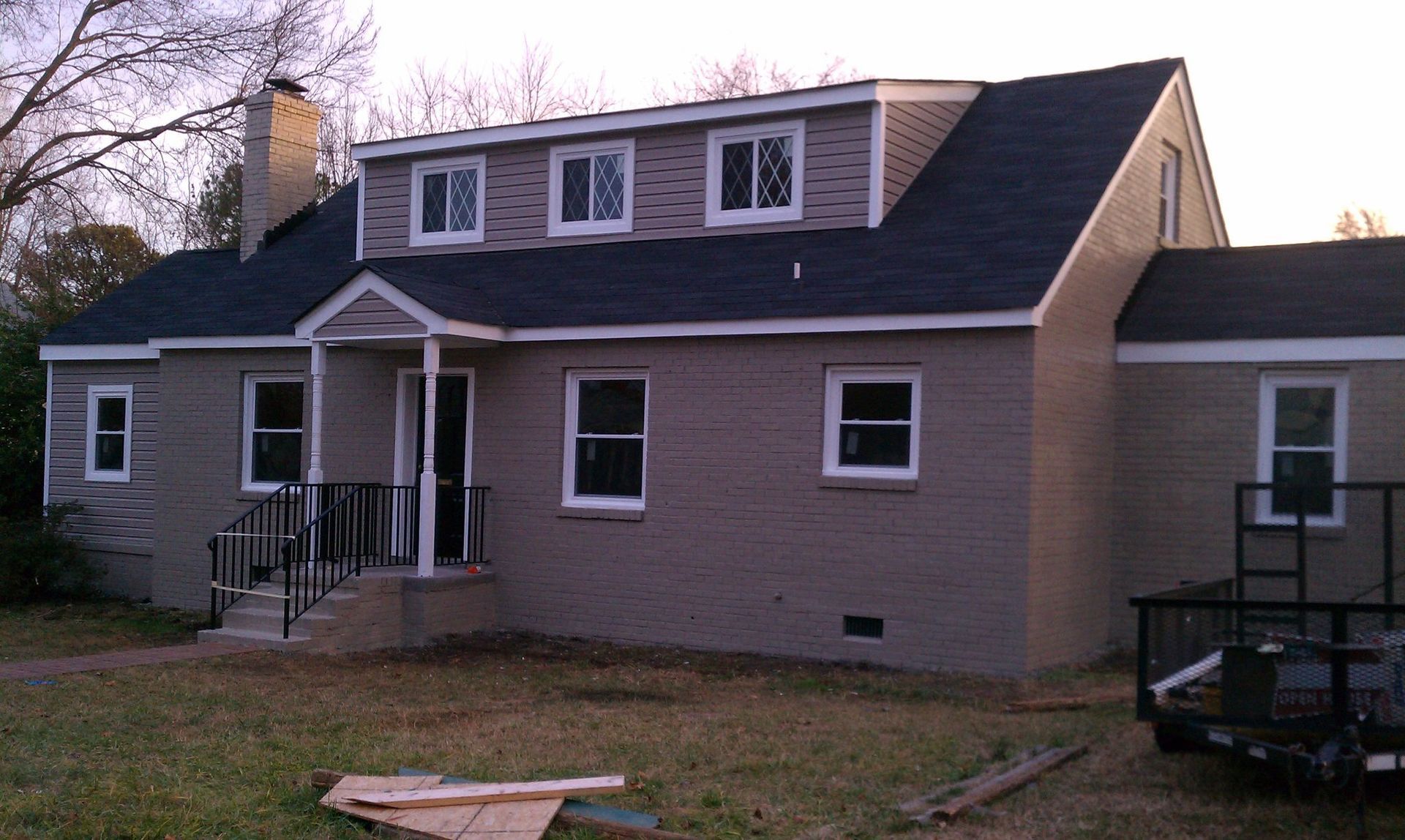A house with a black roof and white windows