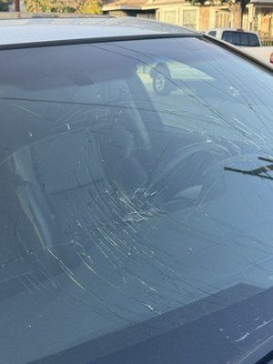 A close up of a broken windshield on a car.