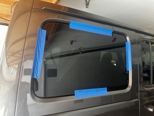 A van is taped to the side with blue tape