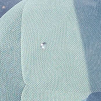 A close up of a piece of fabric with a small hole in it