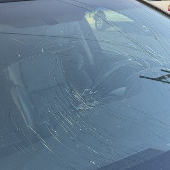 A close up of a broken windshield on a car.
