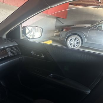 A car is parked in a parking lot next to another car.