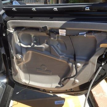 The inside of a car door with the door open