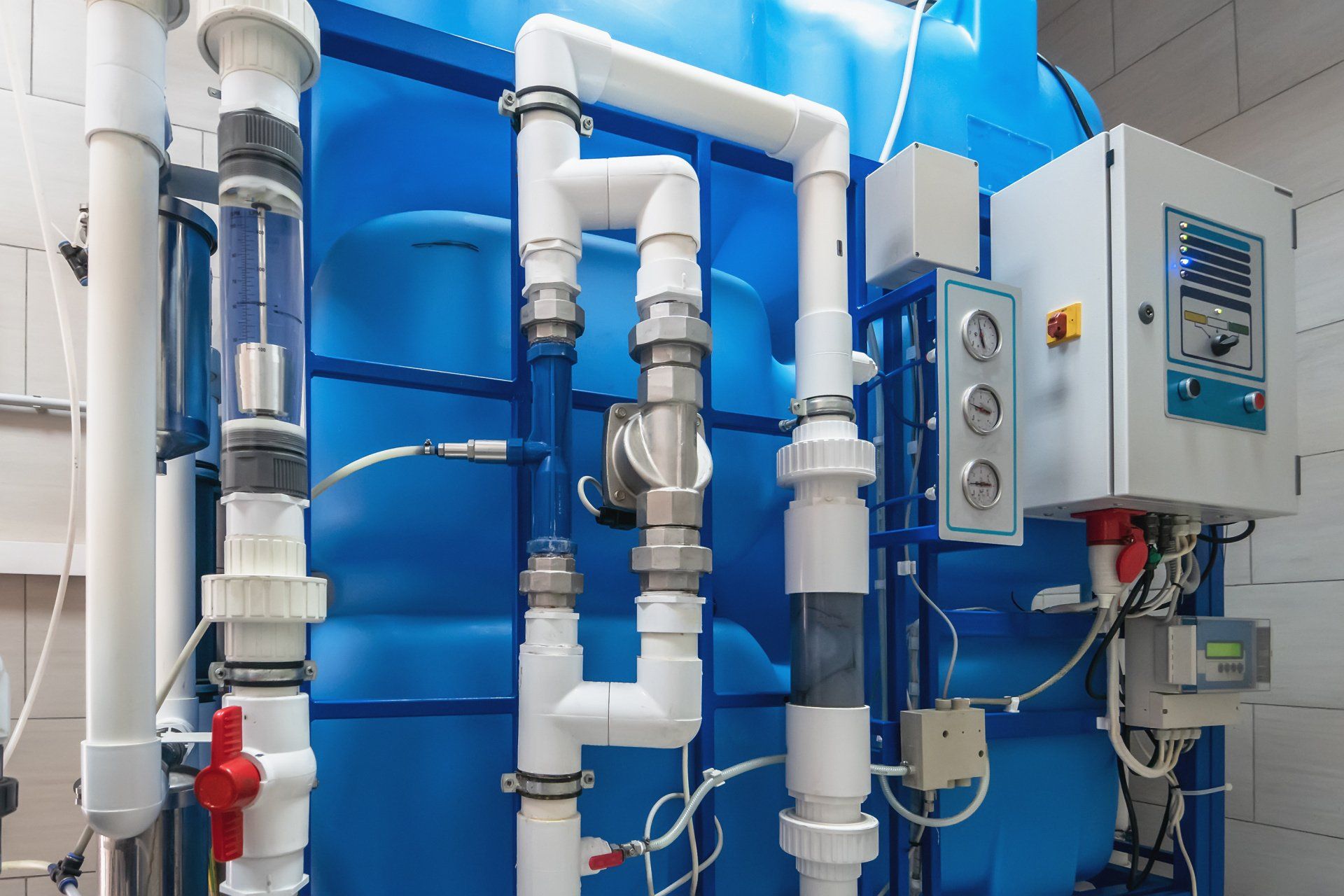 A blue tank with white pipes and a control panel.