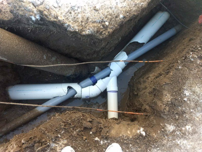 Sewer Pipe — Man Fixing Sewer Pipe in Bay City, MI