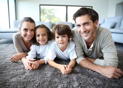 Carpet Restoration — Family at Home Relaxing on Clean Carpet in Flagstaff, AZ