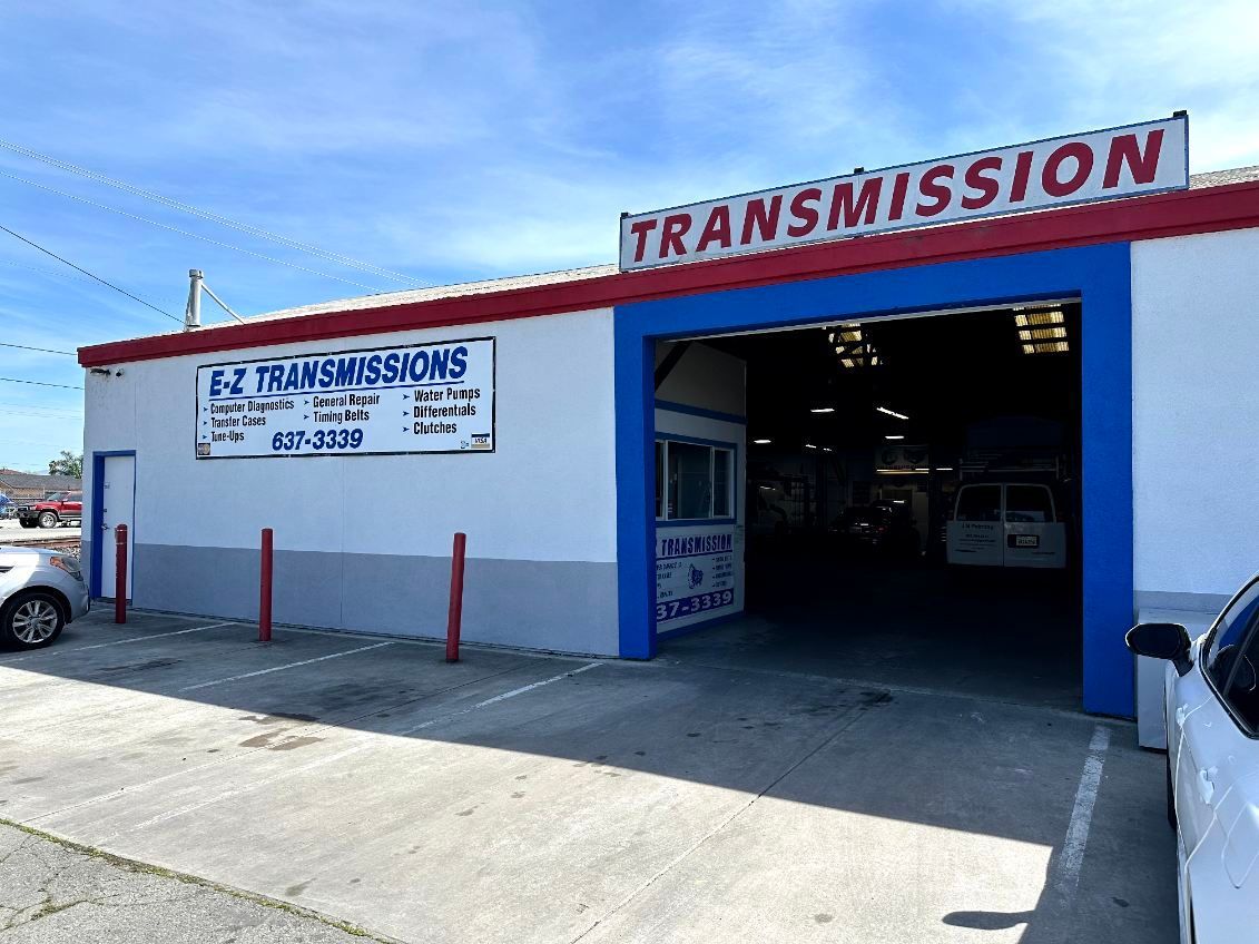 A man is working on a gearbox in a garage.
