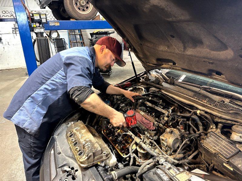 A person is working on the engine of a car.
