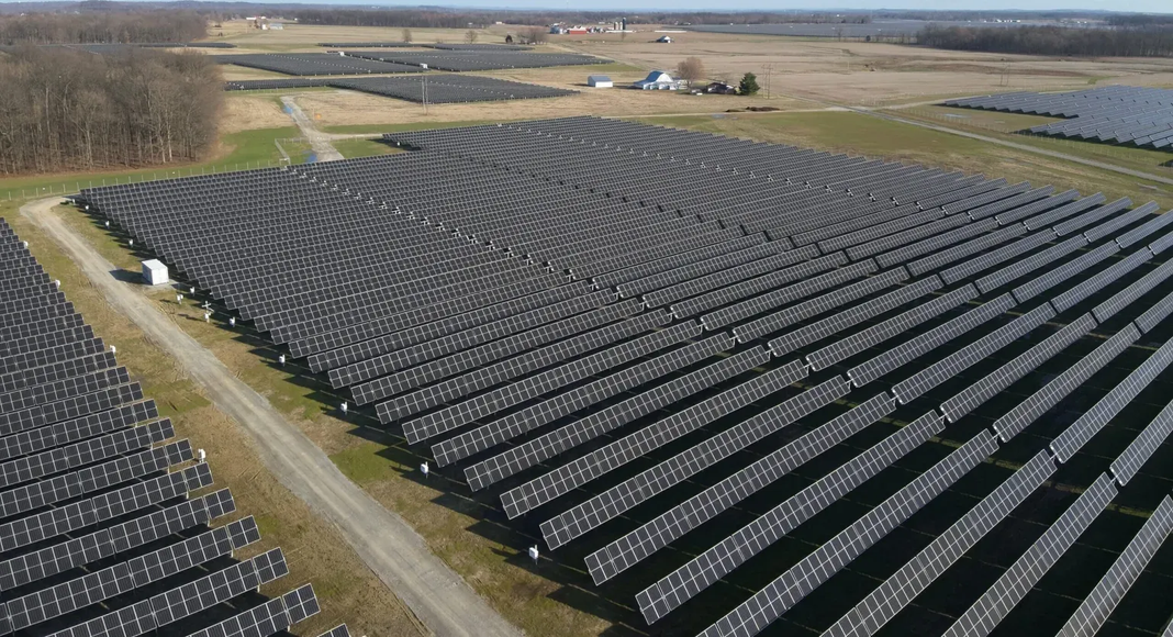 An aerial view of a large field of solar panels.