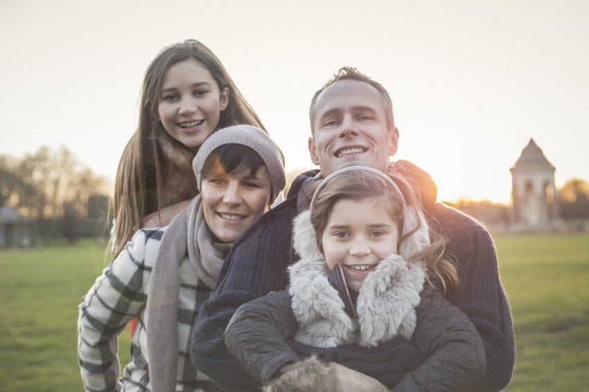 Happy family sitting in nature together