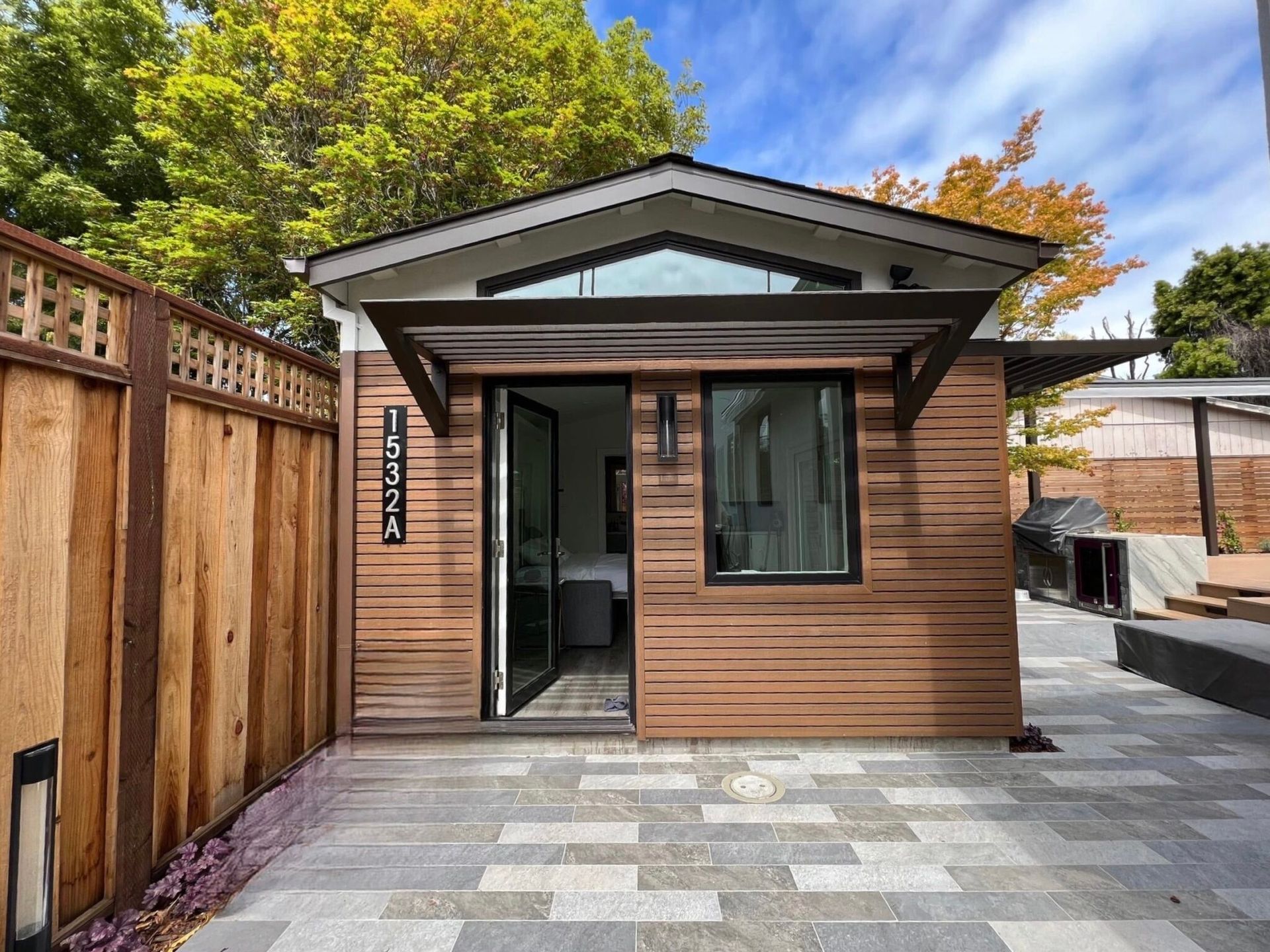 A small house with a wooden fence in front of it