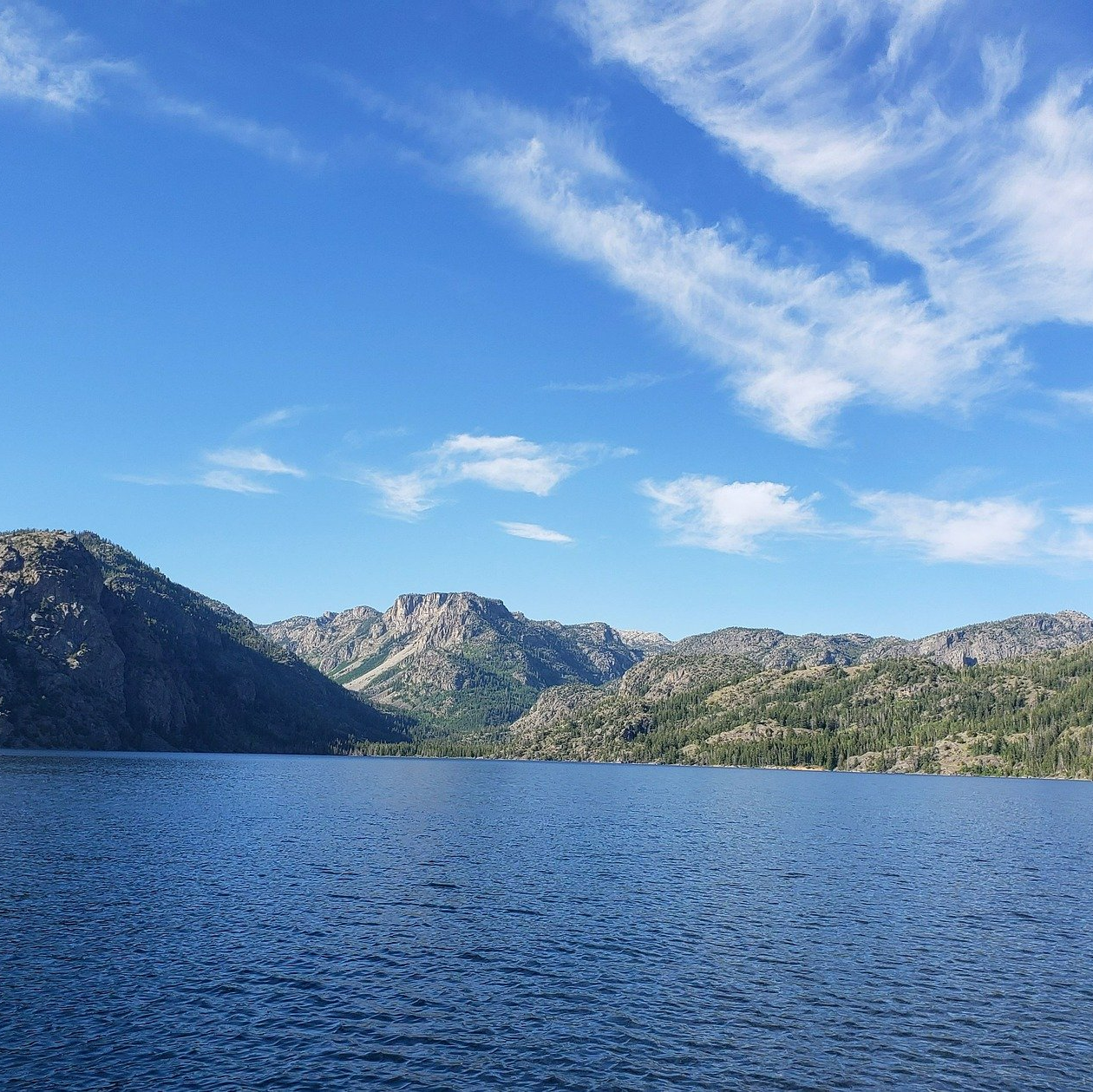 A large body of water with mountains in the background