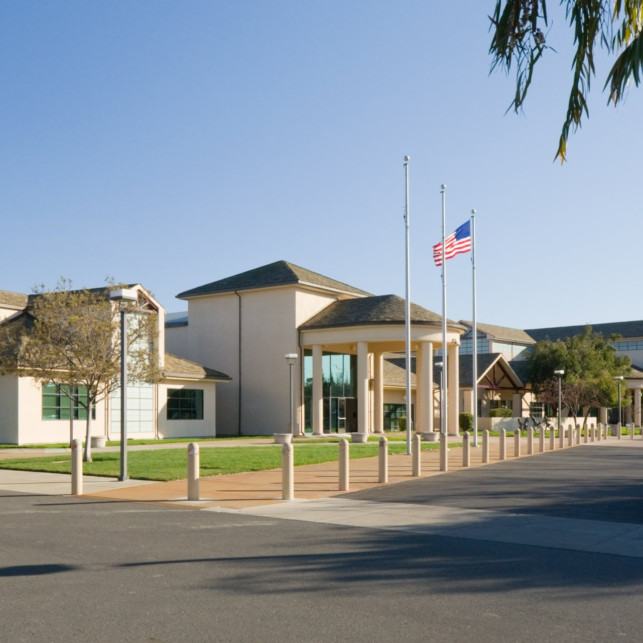 An american flag is flying in front of a large building