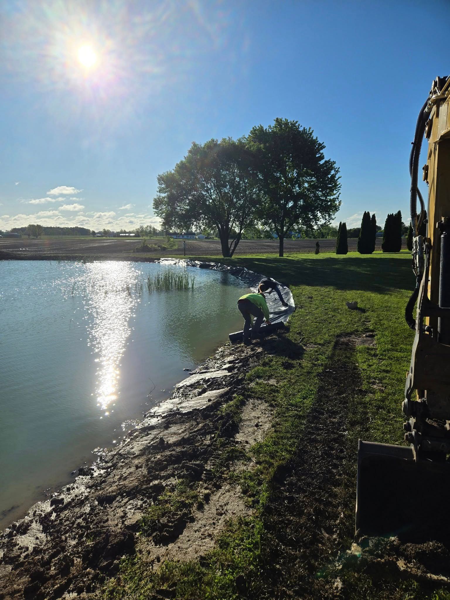 A large body of water with a tree in the background