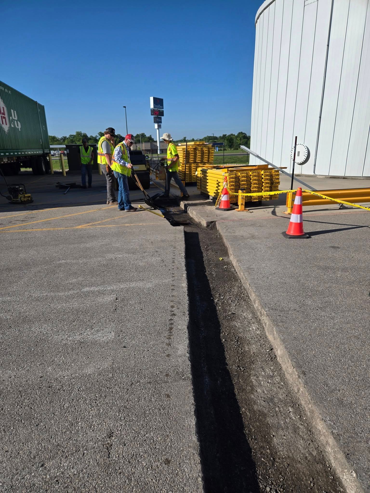 A group of construction workers are working on a road.