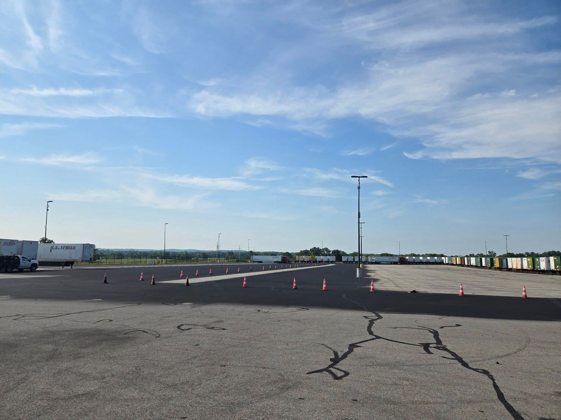 An empty parking lot with a blue sky in the background