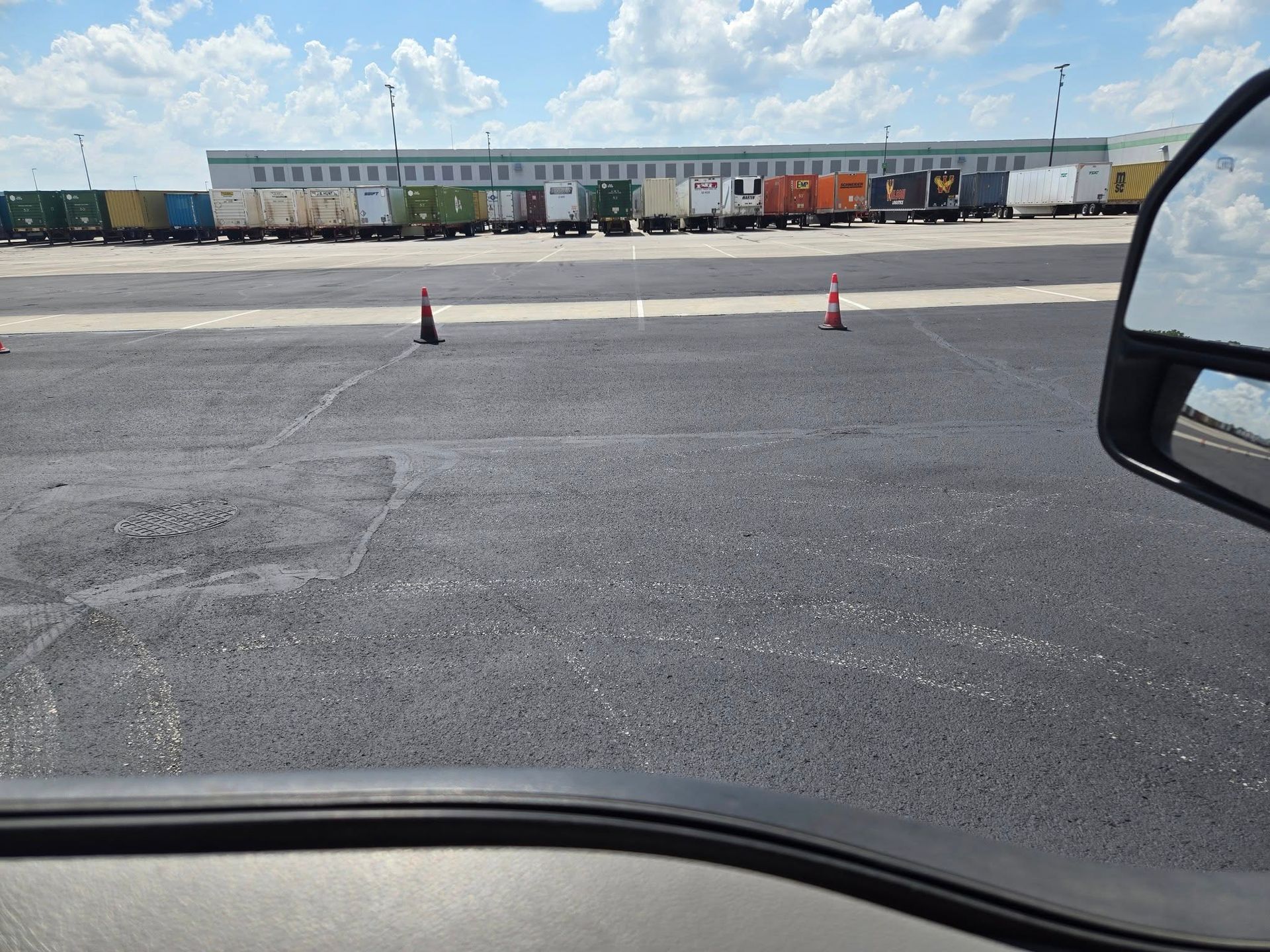 A row of train cars are parked in a parking lot