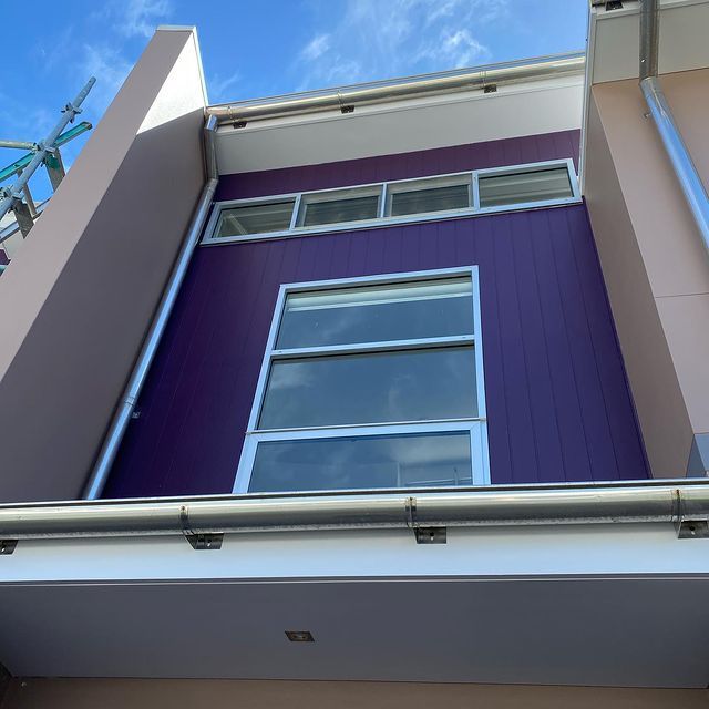 Builder Exterior With Purple Wall — Painting Services in Central Coast, NSW