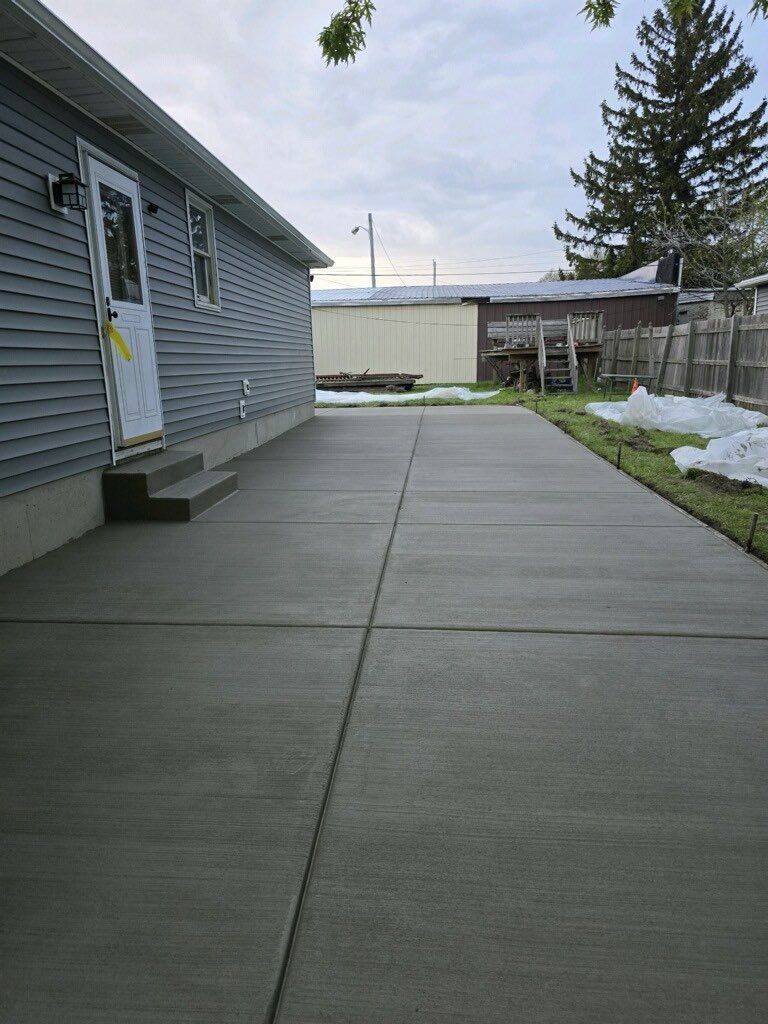 A concrete driveway leading to a mobile home