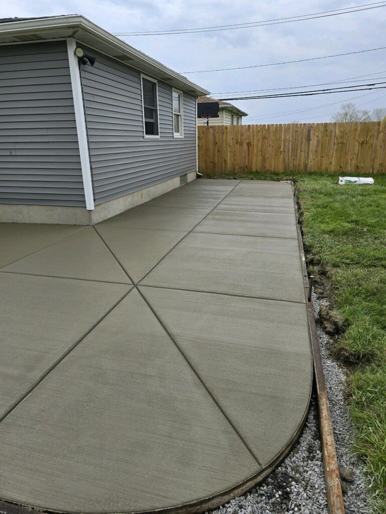 A concrete walkway is being built in front of a house