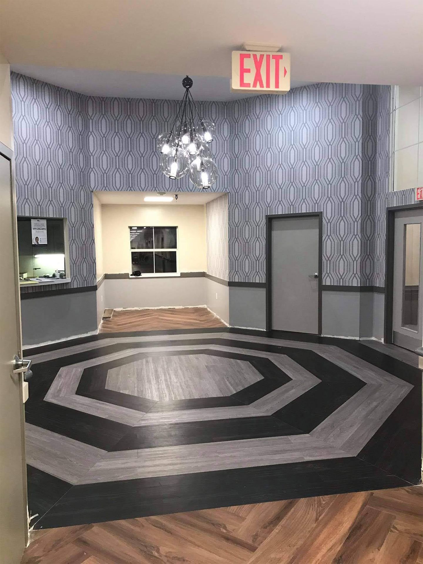 A large room with a circular floor and an exit sign