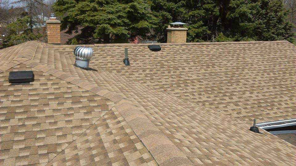 A roof with a chimney and a fan on it