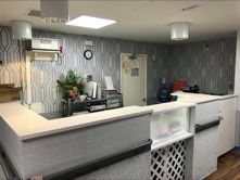 A room with a counter and a clock on the wall