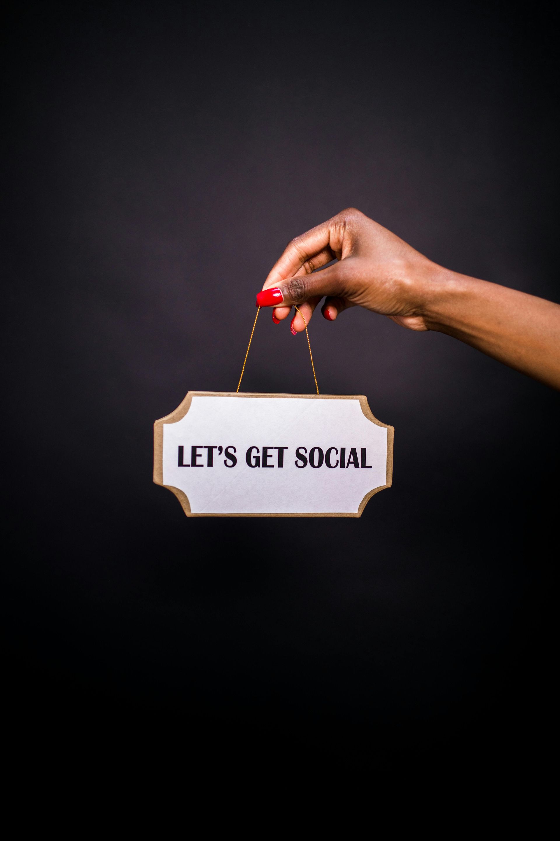 A person is holding a sign that says `` let 's get social ''.