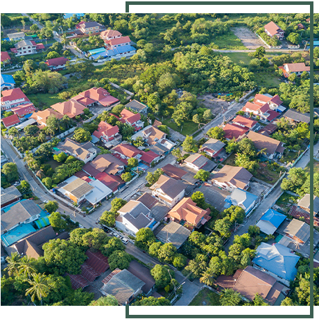 An aerial view of a residential area with lots of houses and trees.