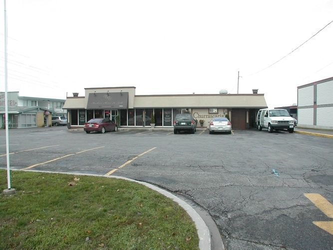 A parking lot with cars parked in front of a building