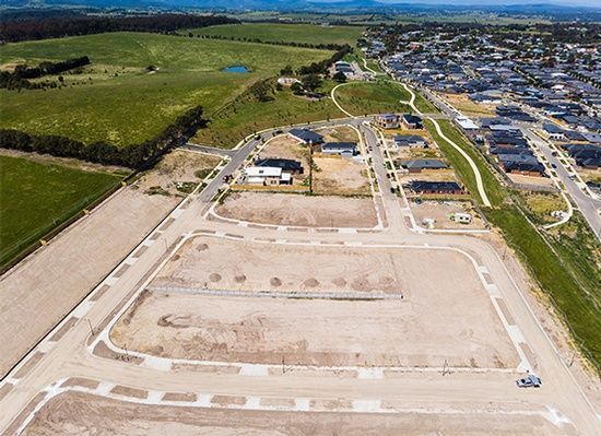 An aerial view of a residential area with lots of houses and fields.