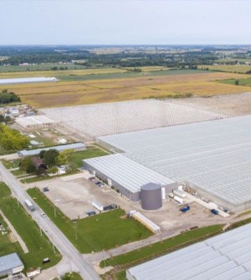 An aerial view of a farm with lots of greenhouses