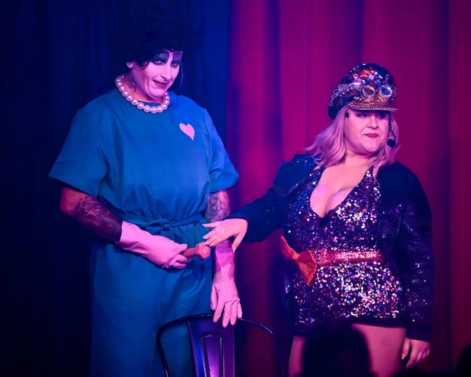 A man and a woman are standing next to each other on a stage — Lux Noir In  Townsville City, QLD