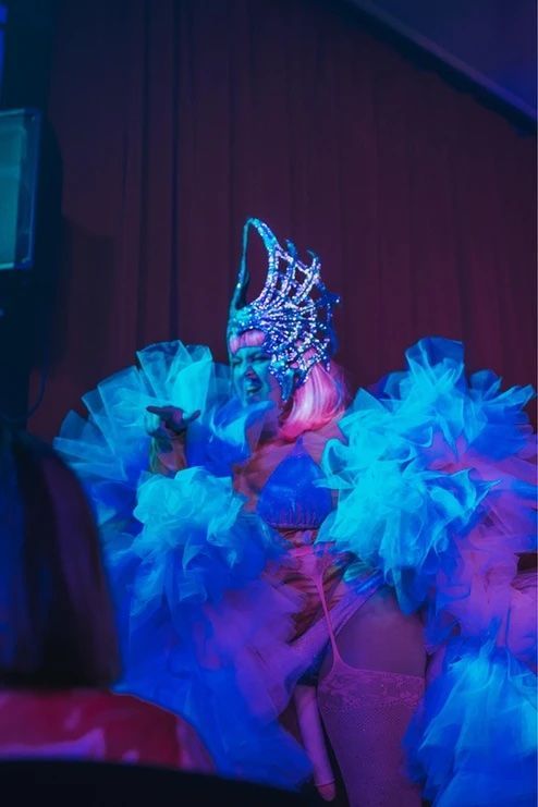A woman in a costume is dancing on a stage in a dark room — Lux Noir In  Townsville City, QLD