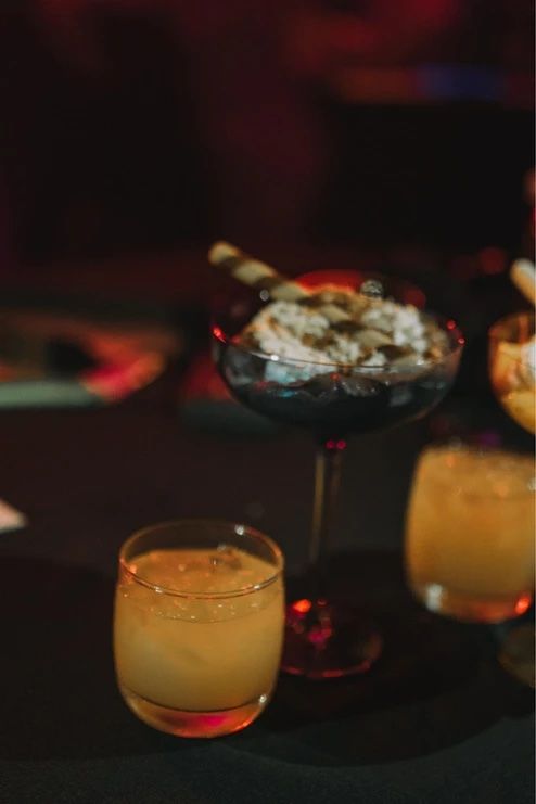 A table topped with a variety of drinks and desserts — Lux Noir In  Townsville City, QLD