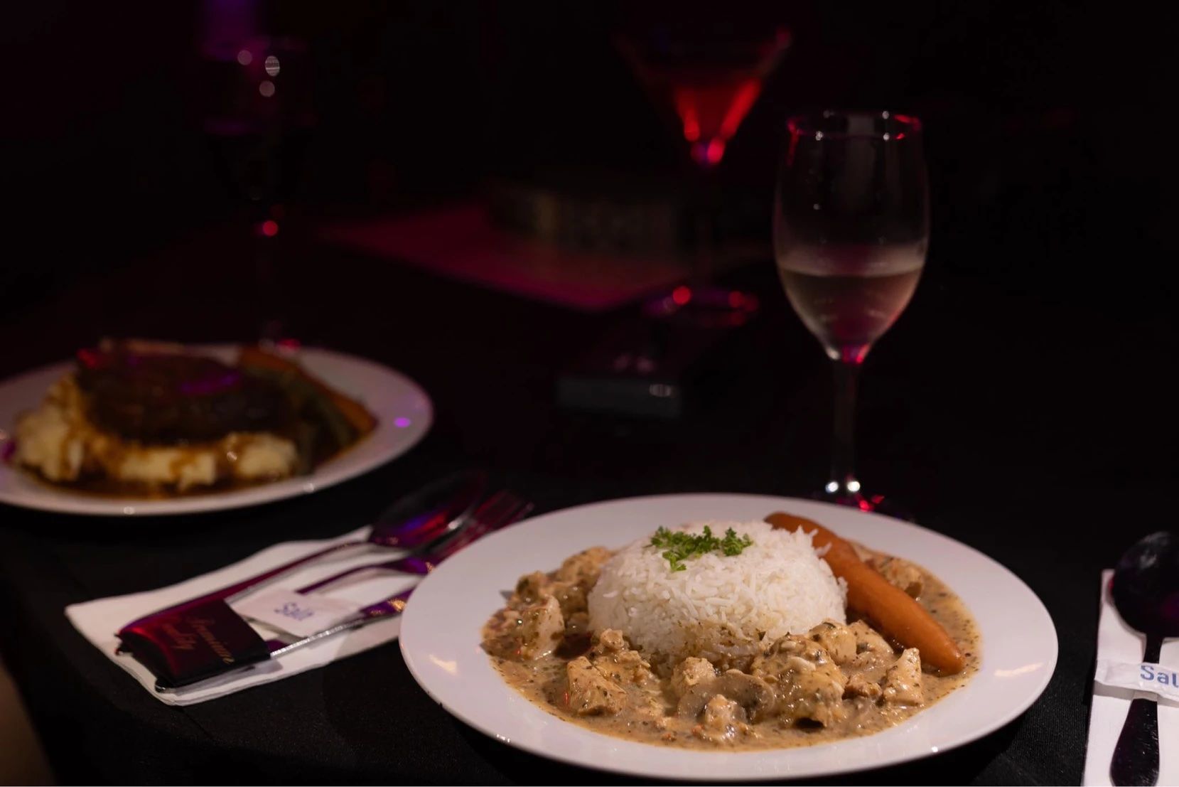 A Woman is Serving Food On a Wooden Tray At a Buffet — Lux Noir In  Townsville City, QLD