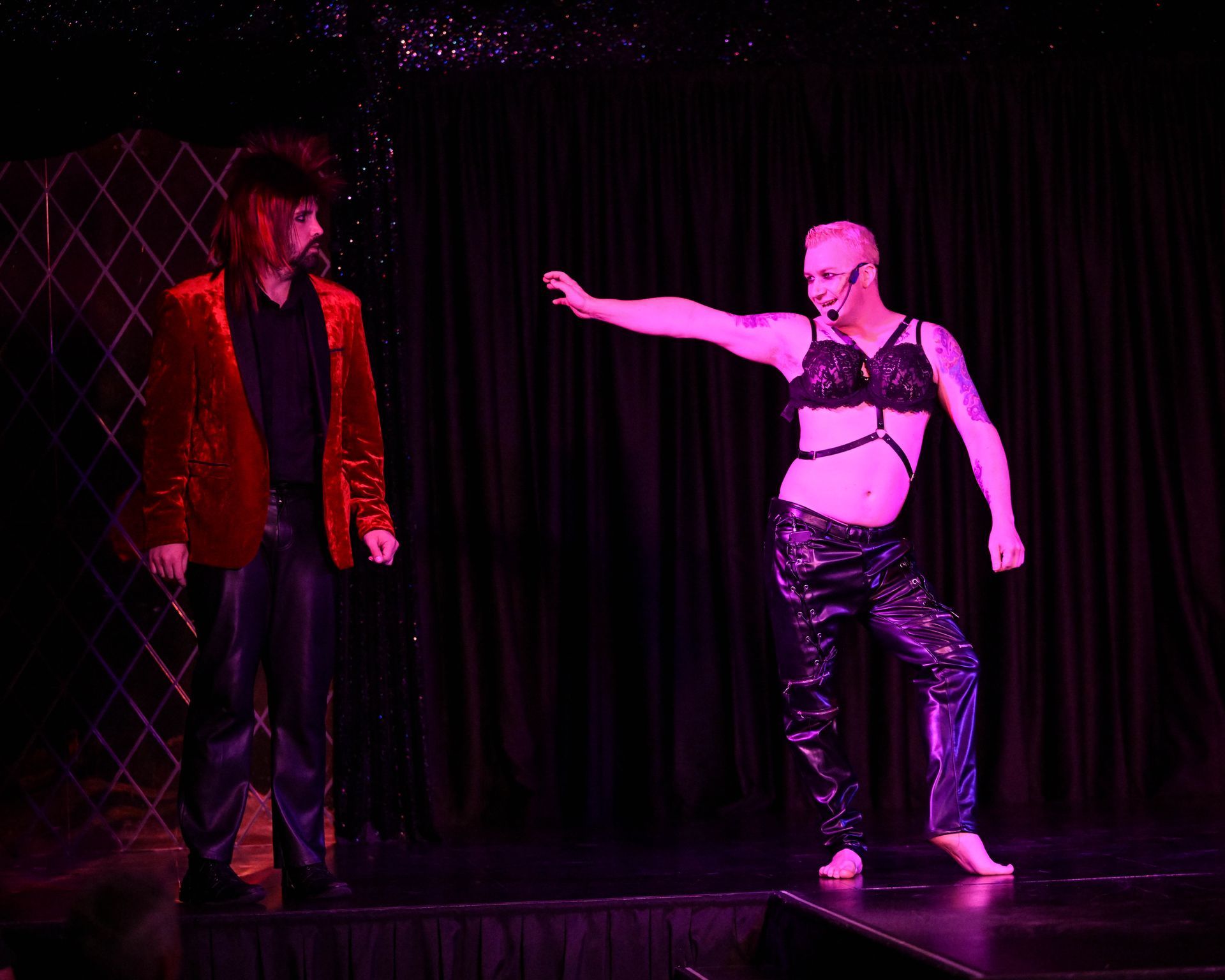 A man is standing next to a woman on a stage — Lux Noir in Townsville City, QLD