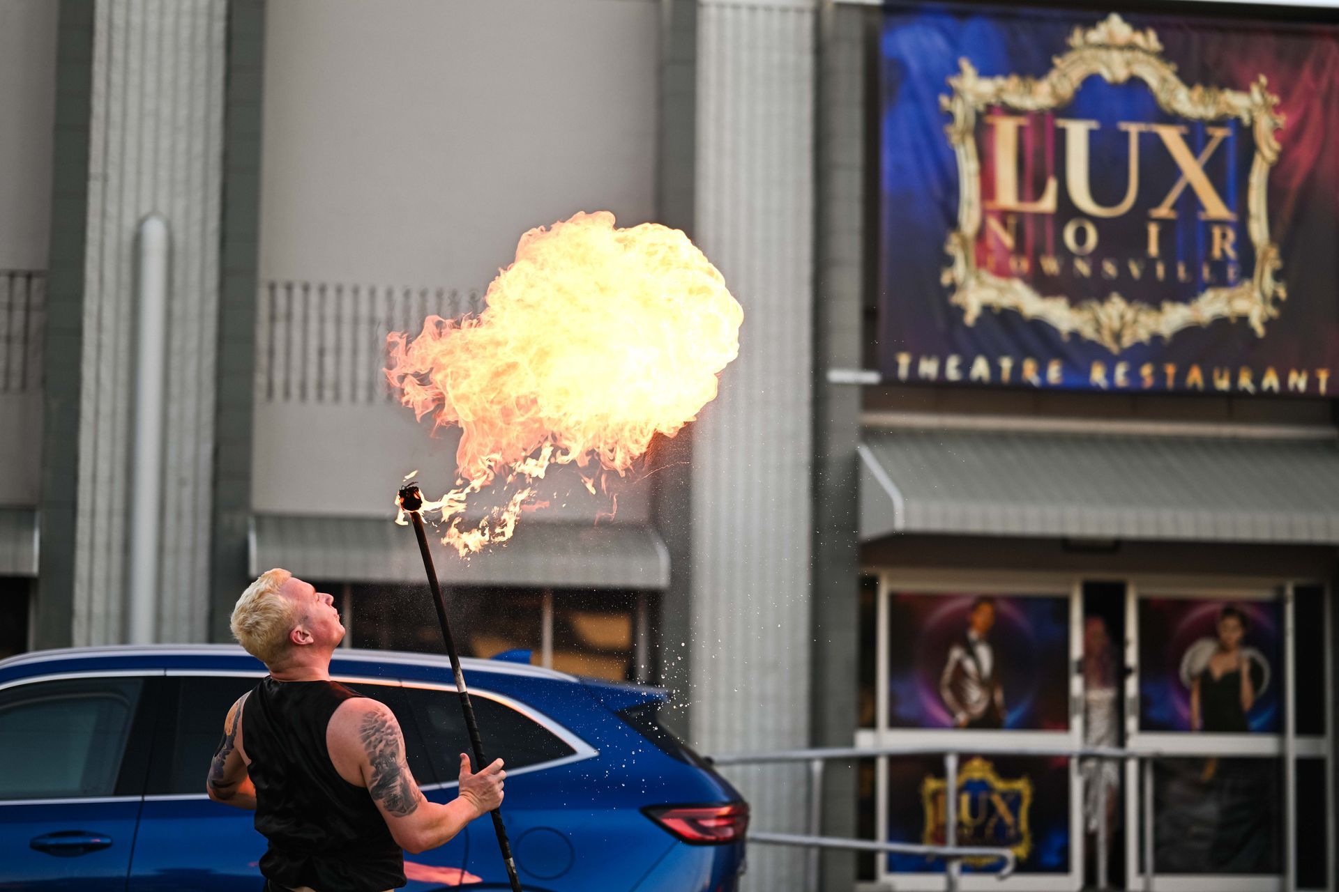 A man is juggling fire in front of a lux noir restaurant — Lux Noir In  Townsville City, QLD