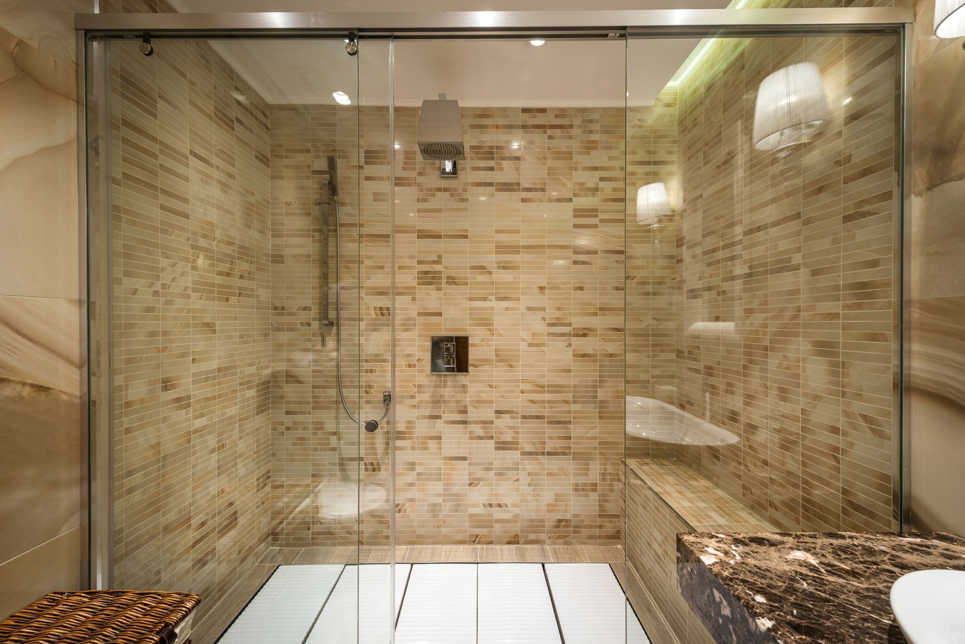 A bathroom with a walk in shower and a sliding glass door.