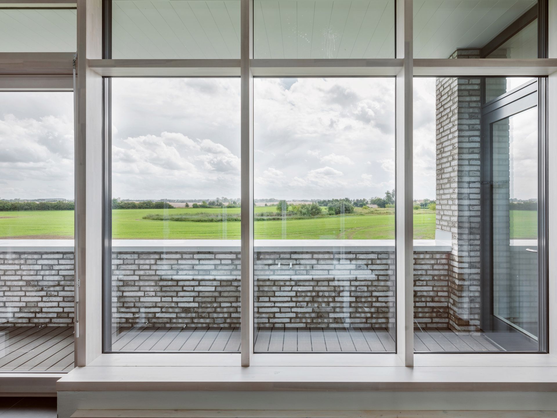 A large window with a view of a field