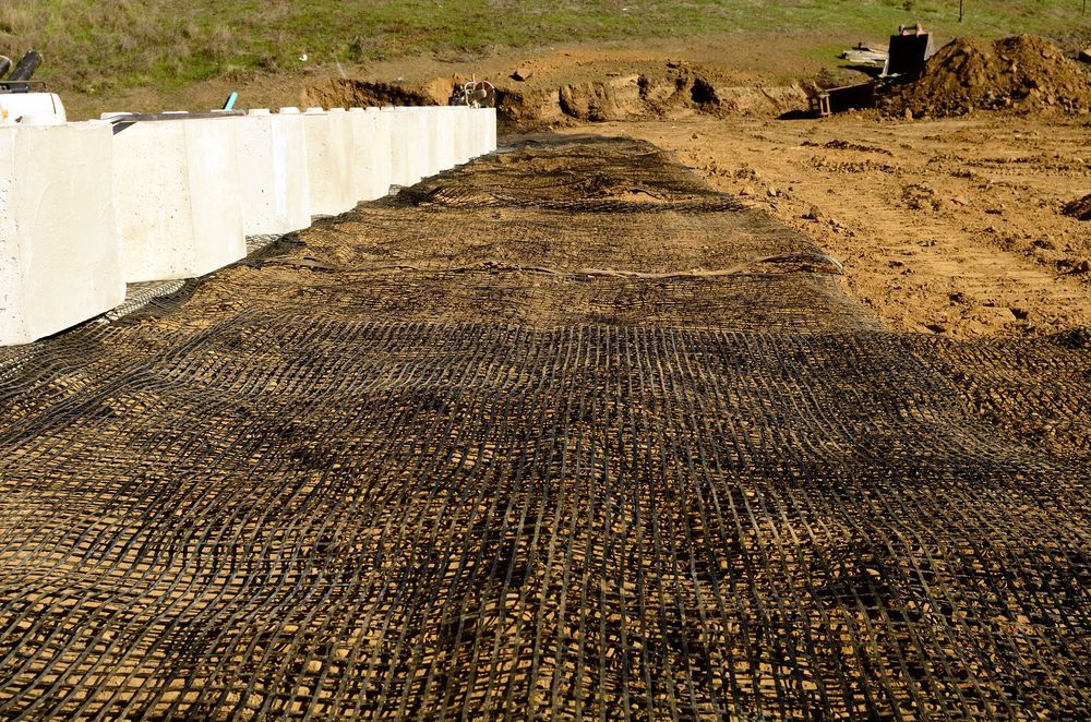 Brick Wall With A Few Plants Growing On It — Diamond Concreting In Mount Low, QLD