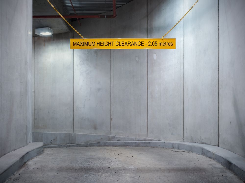 Maximum Height Clearance Sign Hangs From The Ceiling Of A Parking Garage — Diamond Concreting In Mount Low, QLD