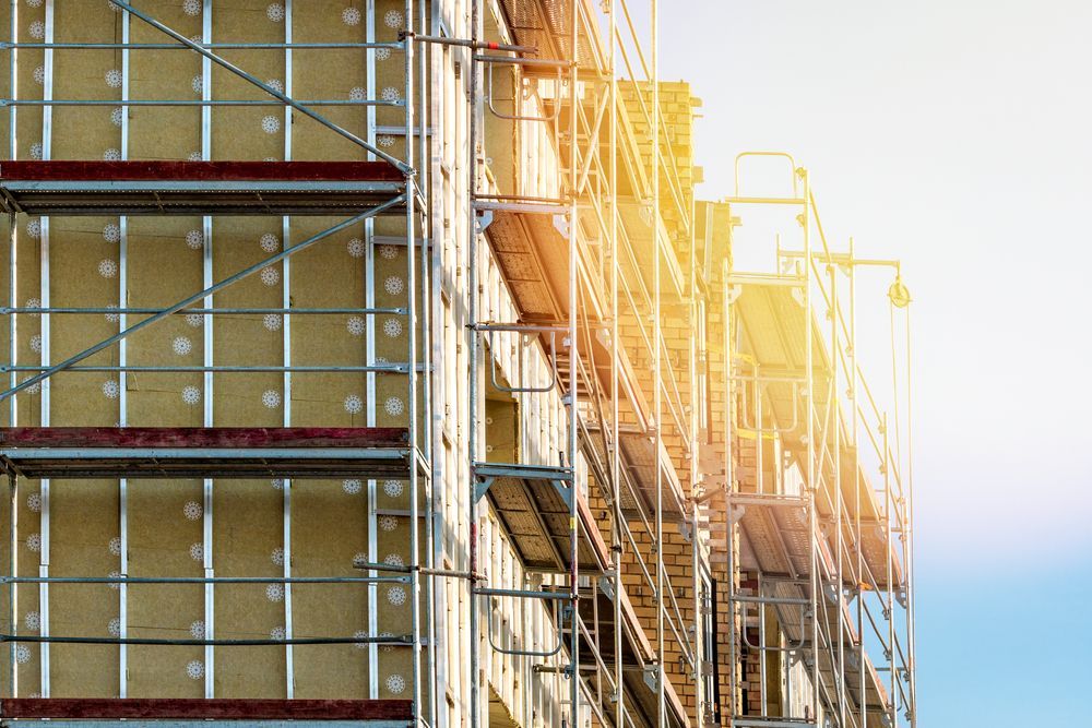 Building Under Construction With Scaffolding On The Side Of It — Diamond Concreting In Mount Low, QLD