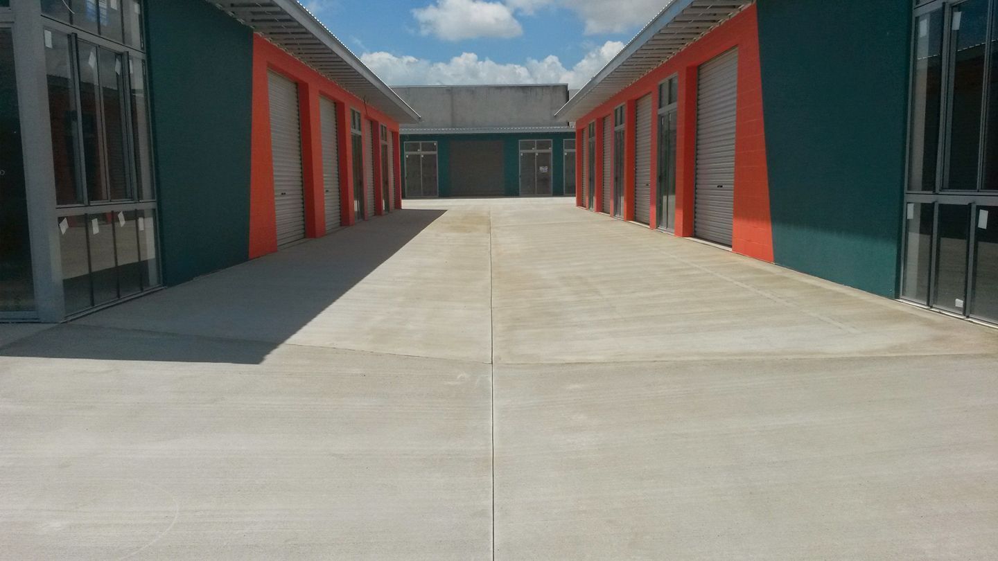 Family Crosses A Street In Front Of A Crosswalk Sign — Diamond Concreting In Mount Low, QLD