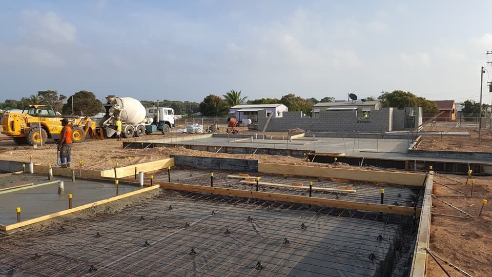 Stone Wall With Stairs Leading Up To A House — Diamond Concreting In Mount Low, QLD
