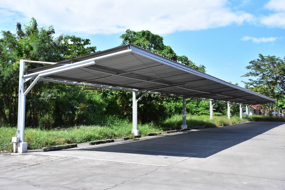 Parking Lot With A Canopy Over It And Trees — Diamond Concreting In Mount Low, QLD