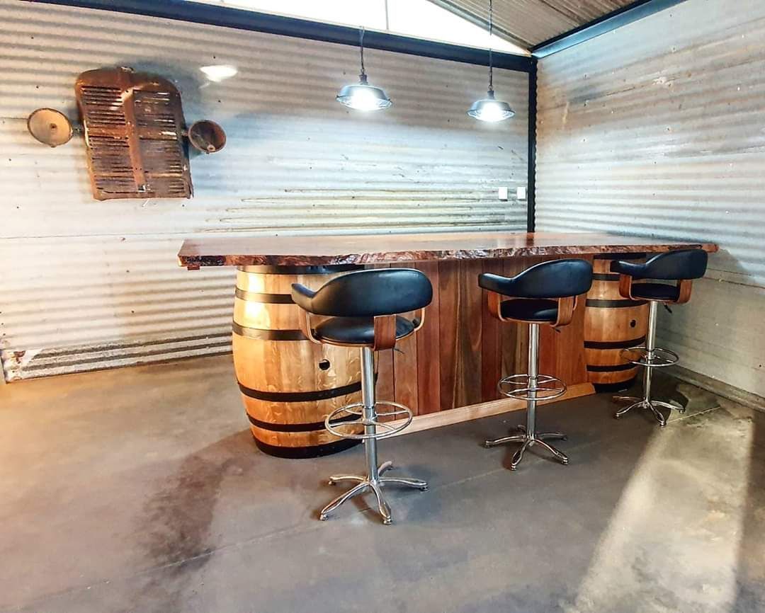Room With A Bar Made Out Of Wooden Barrels And Stools — Diamond Concreting In Mount Low, QLD