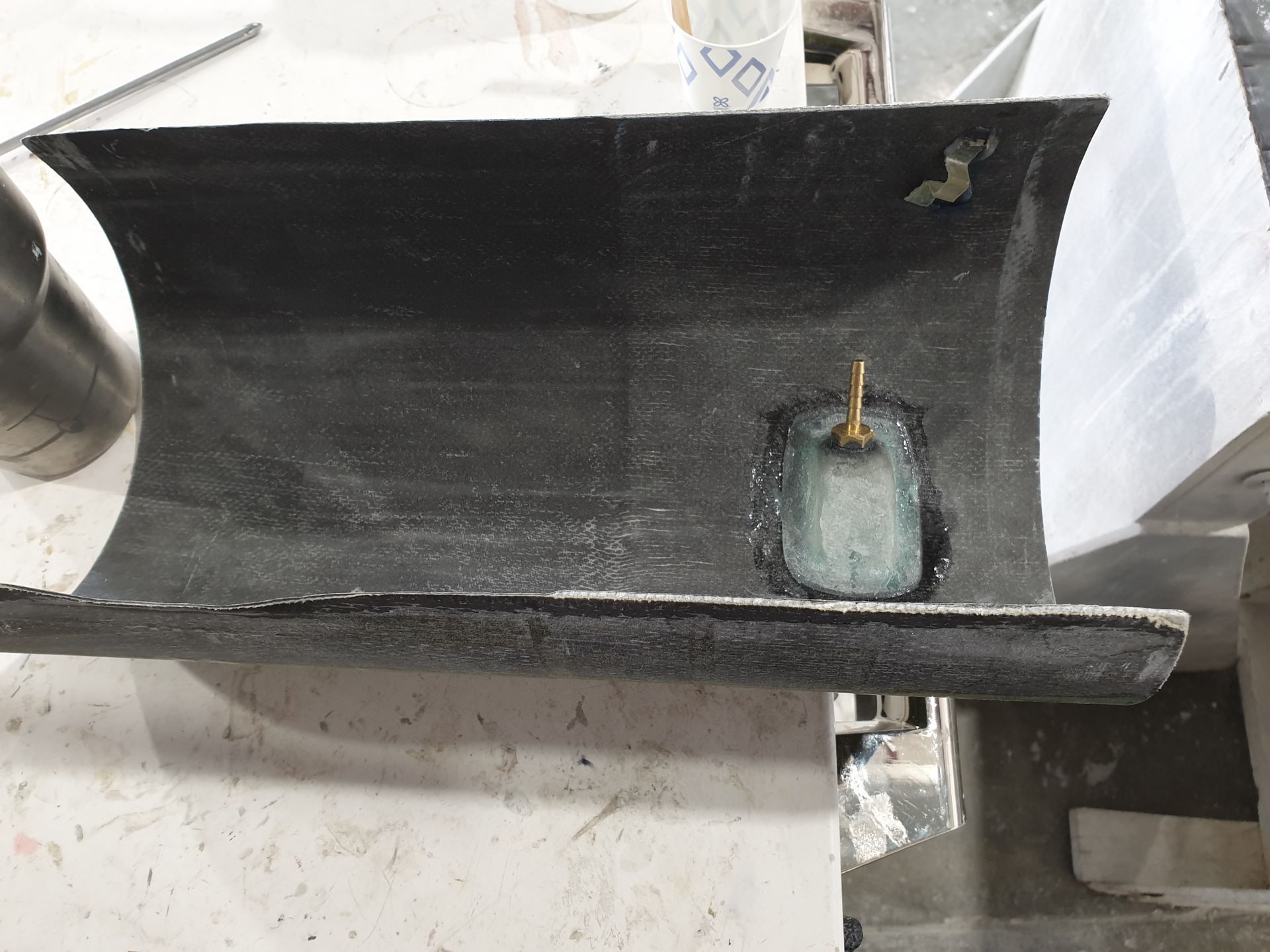 A piece of metal with a hole in it is sitting on a table.